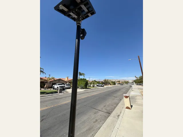 A street photograph of a pole-mounted camera and solar panel. Read the linked article for the campaign’s position.