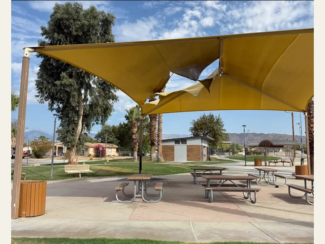 A photograph of damaged shade canopies at a Desert Hot Springs park.